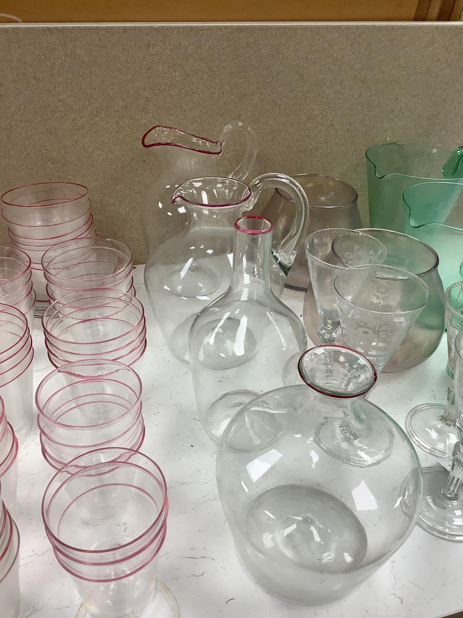 Venini Murano glass vases, jugs and carafes with red trailed rims, tallest 24 cm, la Murrina sets of glass bowls , a lemonade set, a set of Murano table glass with trailed pink rims etc.